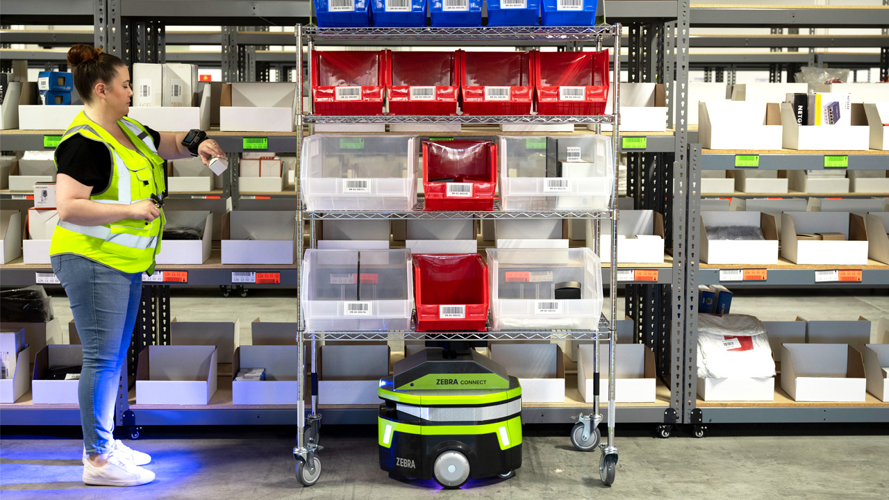 Zebra Symmetry Fulfillment Picker in Aisle with Robot and Cart