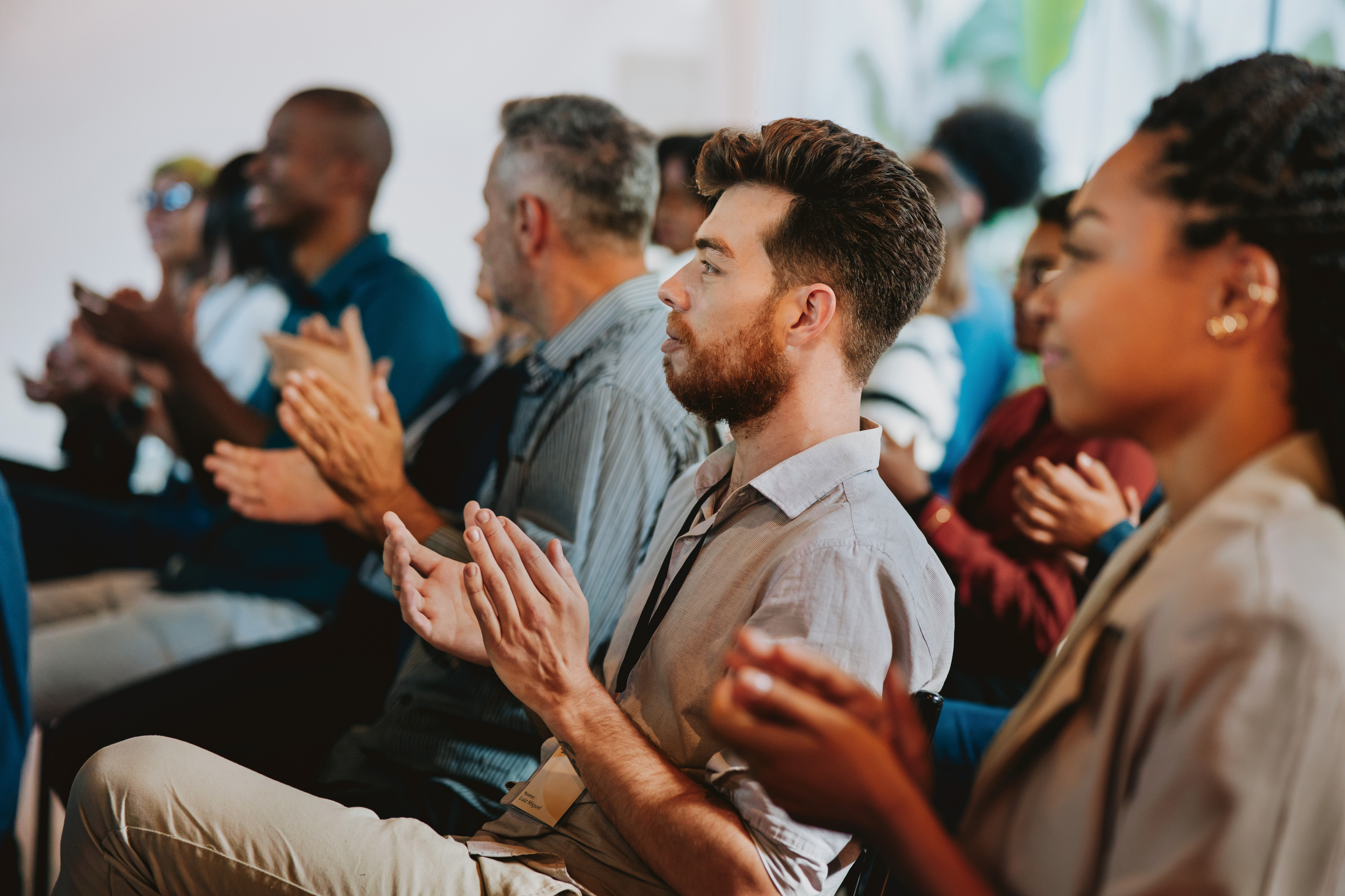 An audience applauding during a presentation.