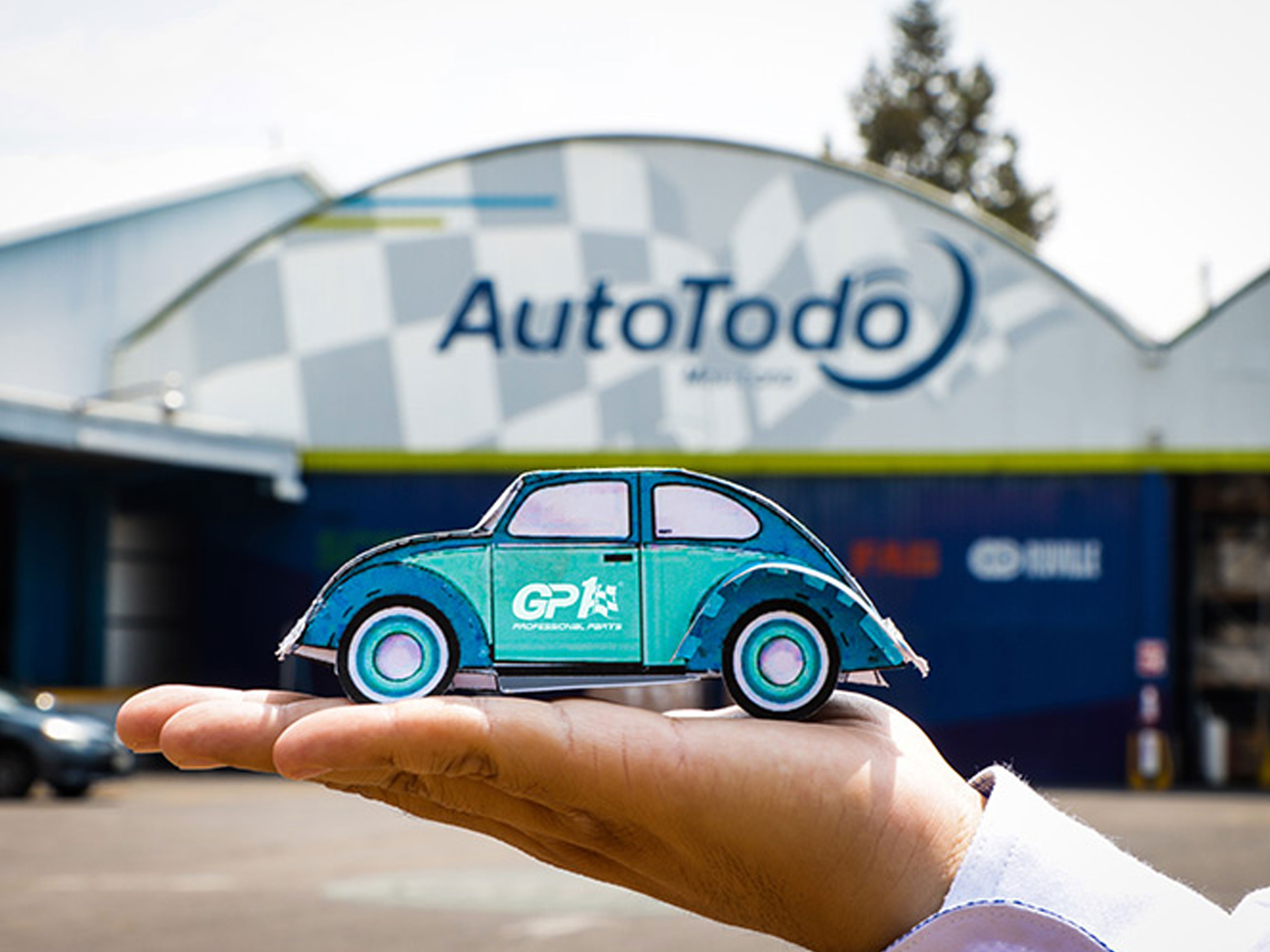 AutoTodo employee holding a car