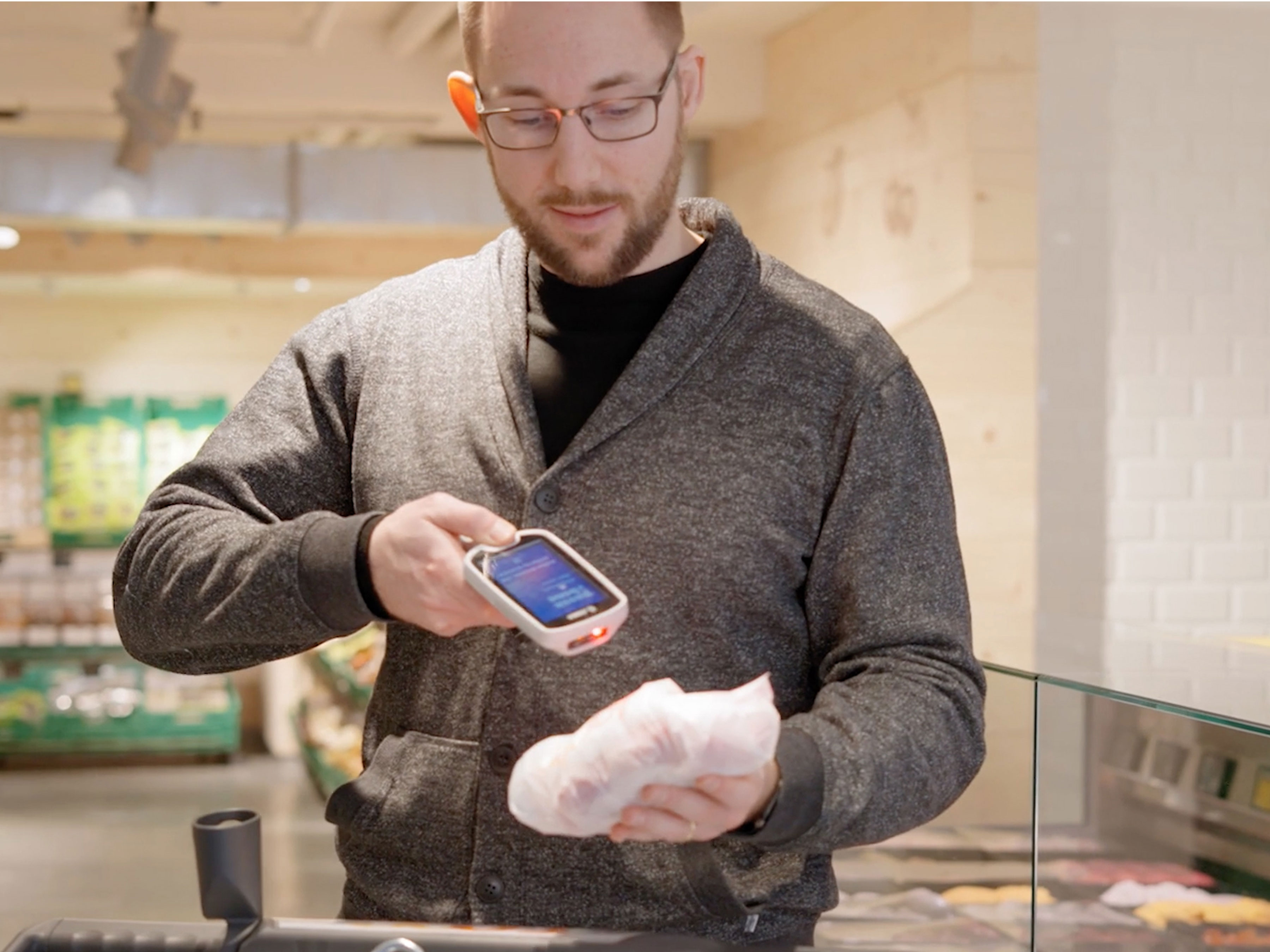 Man using Zebra PS20 device to scan food