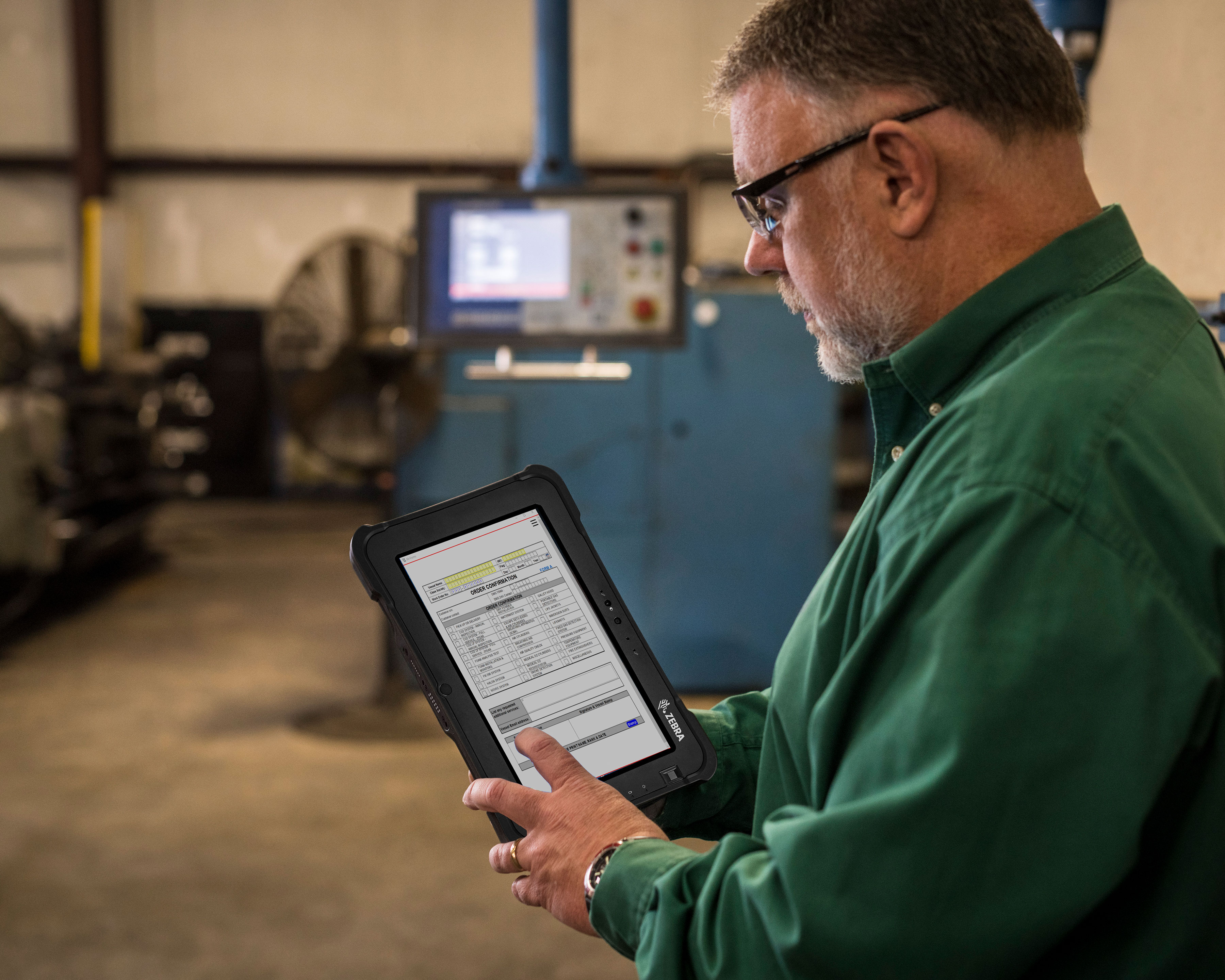 Worker uses Zebra L10 rugged tablet to order manufacturing equipment