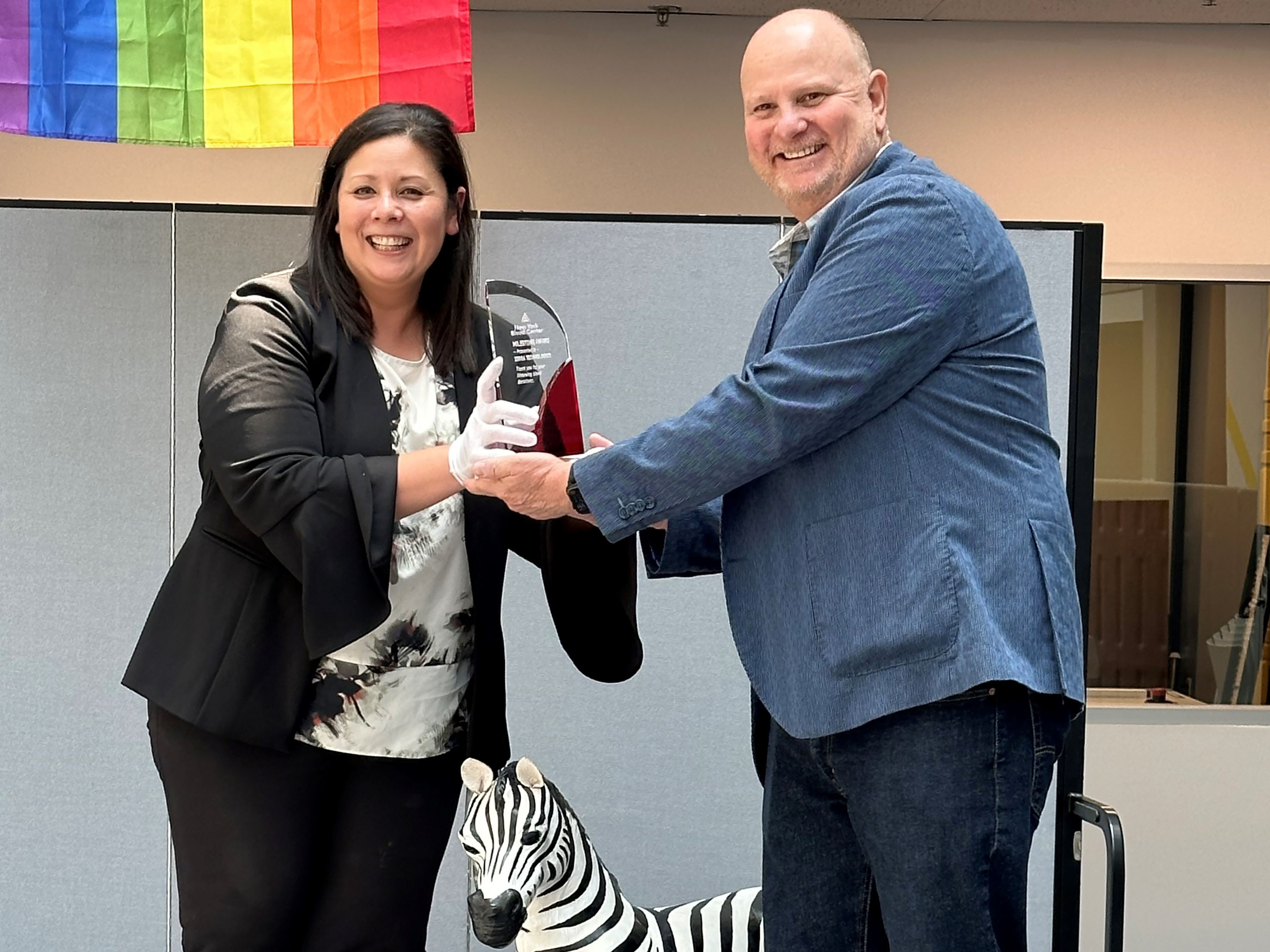 Steve Legoff from Zebra accepts the award from a New York Blood Center representative for the most corporate blood donations