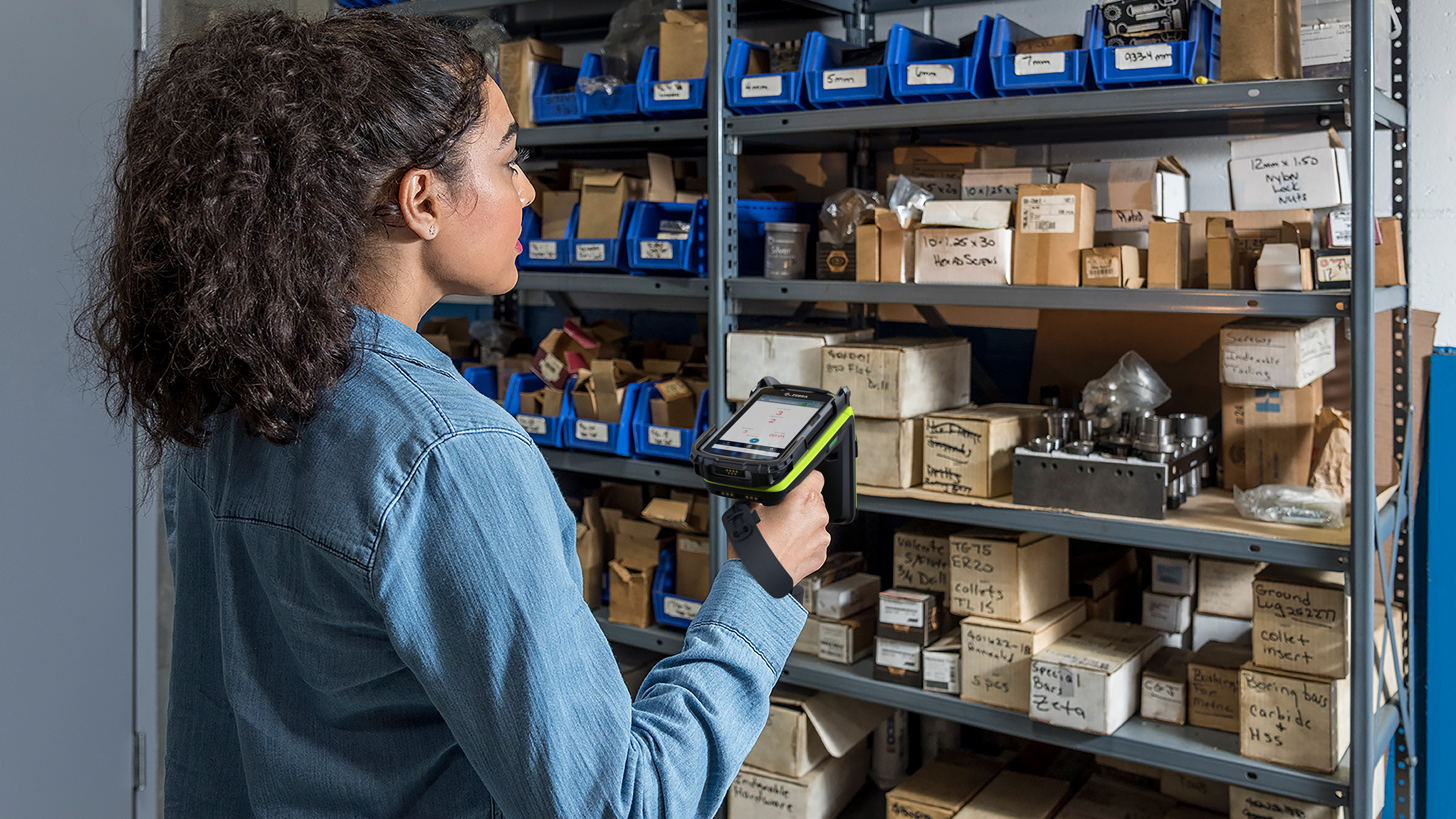 Warehouse worker scanning items on shelves using a Zebra Rugged Scanner