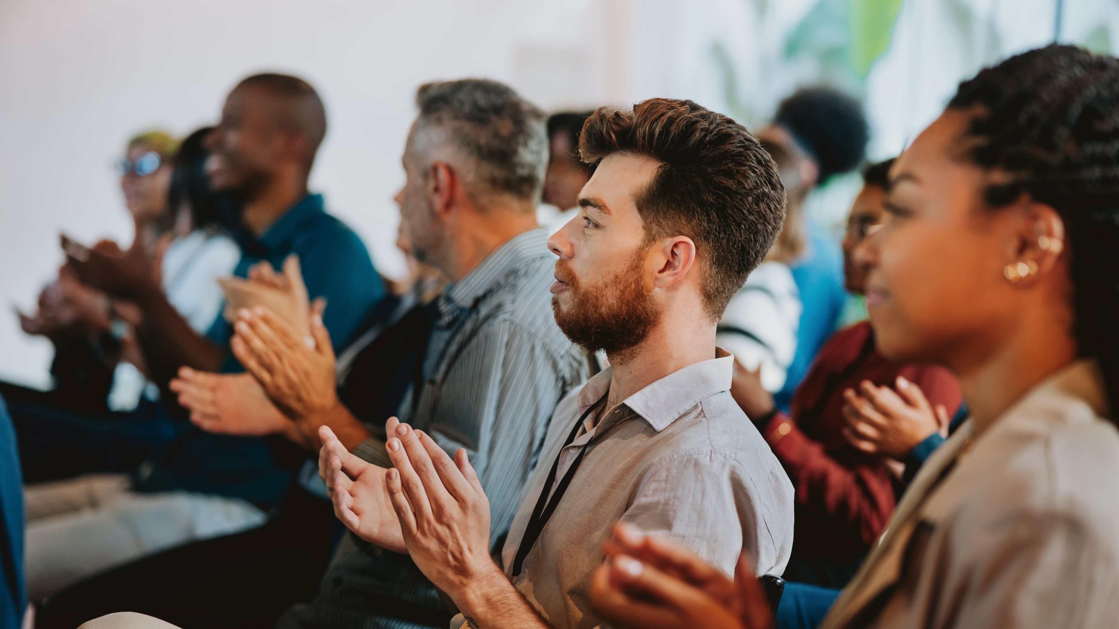An audience applauding during a presentation.