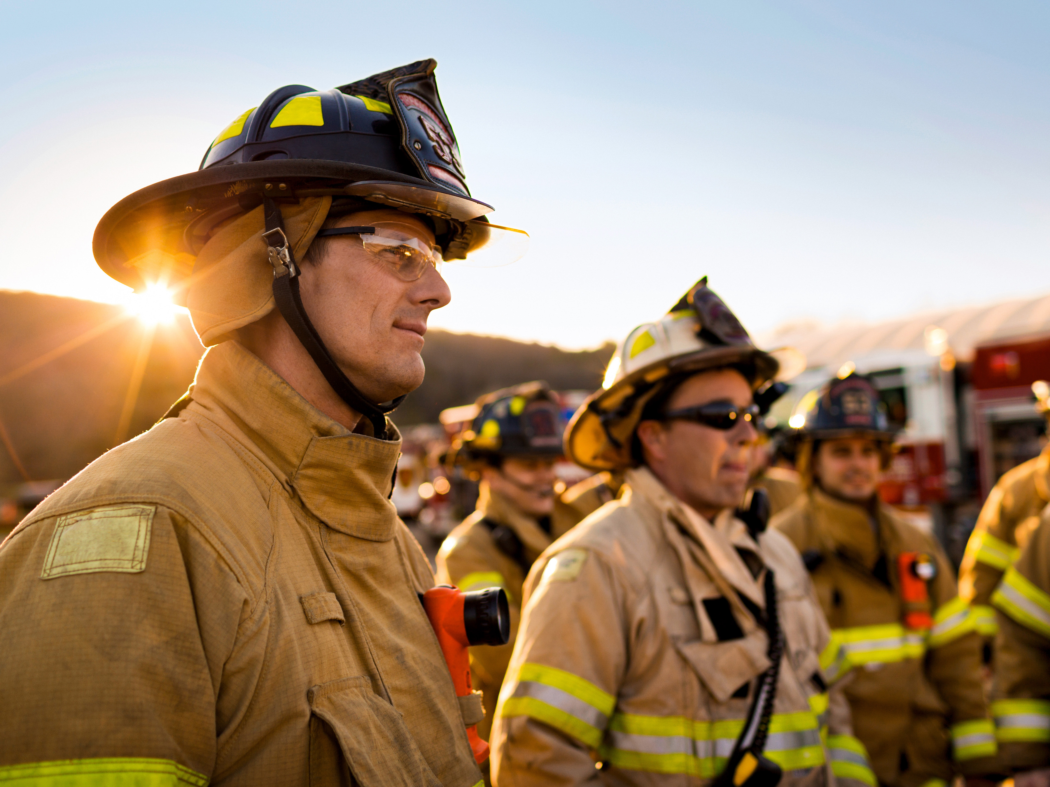 Firefighters standing in a group outside.
