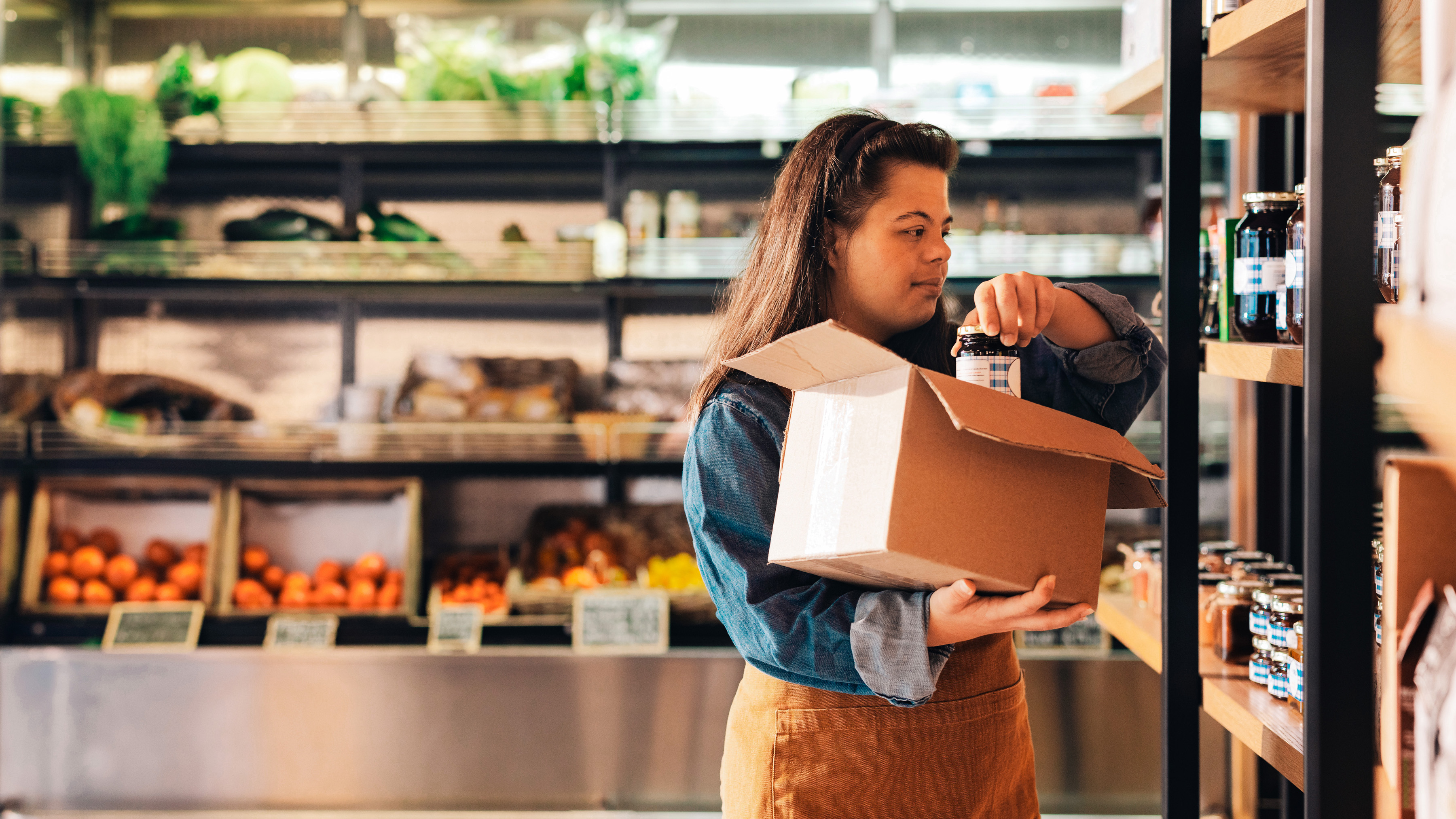 Employee restocking in a grocery store. 
